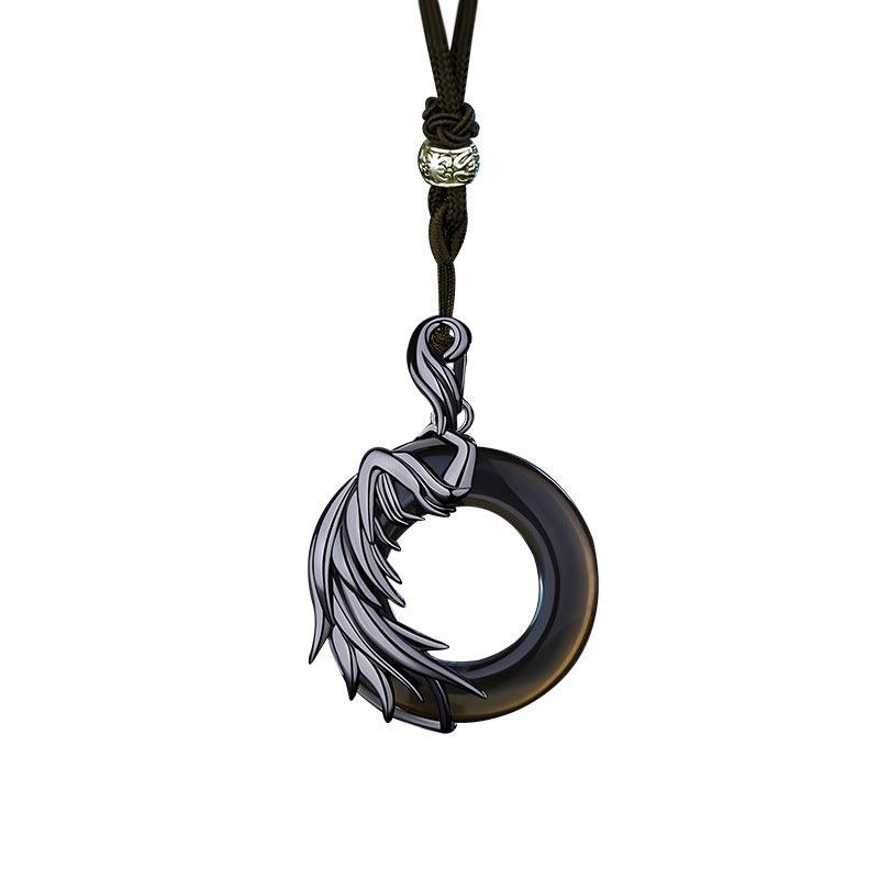 Black jade pendant with an artistic flowing figure design on a fine silver chain, exuding elegance and mystique.